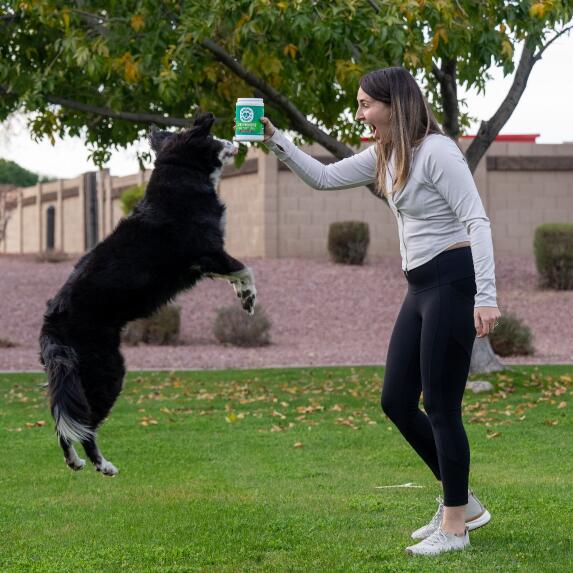 woman kissing dog