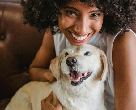 woman giving dog a treat